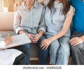 Teenager patient with parents consulting with gynecologist or psychiatrist doctor for women's healthcare medical examination or teen's mental health consultation in clinic exam room 