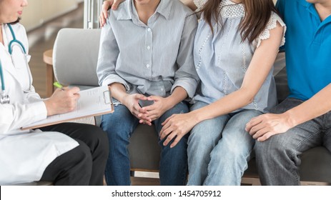 Teenager patient with parents consulting with gynecologist or psychiatrist doctor for women's healthcare medical examination or teen's mental health consultation in clinic exam room 