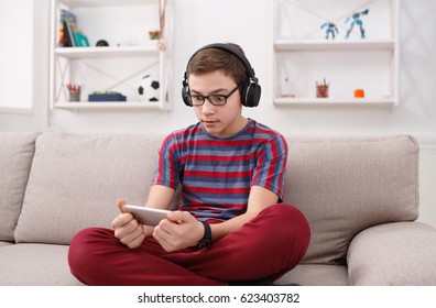 Teenager Play Online Game At Mobile Phone At Home. Addiction Concept