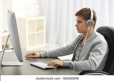 Teenager Playing Computer Game At Home