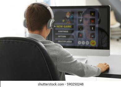 Teenager Playing Computer Game At Home