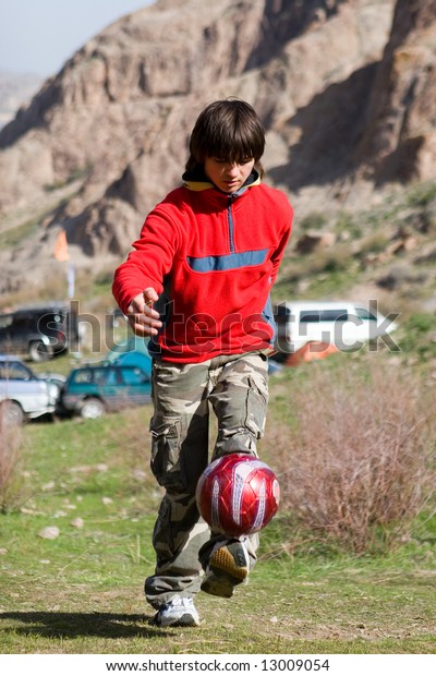 Teenager playing football (series Sport,\
Extreme, Mountain, Horses and\
Teenagers)