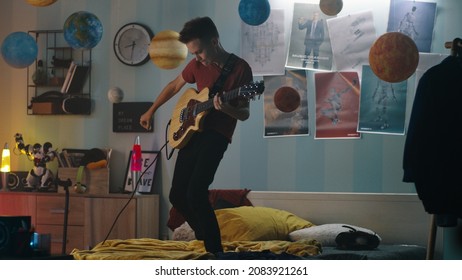 Teenager playing guitar in bedroom - Powered by Shutterstock