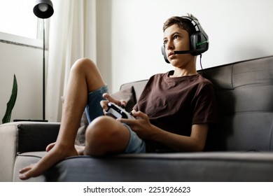 Teenager playing video games at home - Powered by Shutterstock