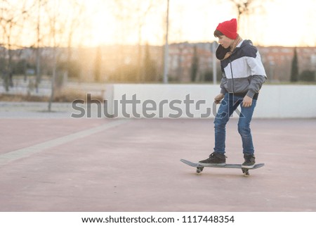 teenager practicing with skateboard at sunrise city