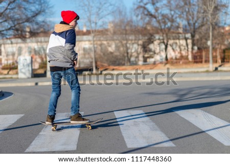 Similar – teenager practicing with skateboard at sunrise city