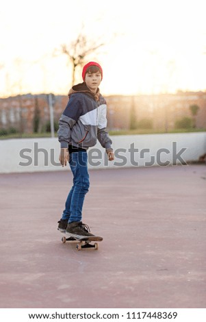 Similar – teenager practicing with skateboard at sunrise city