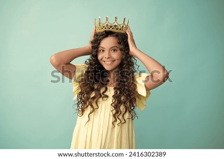 Teenager princess child celebrates success win and victory. Teen girl in queen crown. Happy teenager, positive and smiling emotions of teen girl.