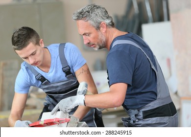 Teenager With Professional Brick Layer In Training School