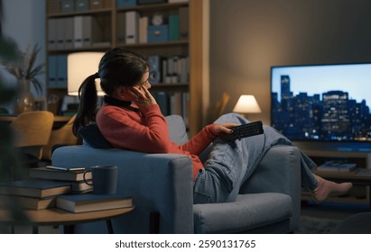 Young person relaxing at home watching TV