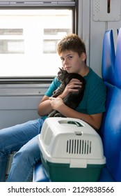 A teenager rides a train with cat