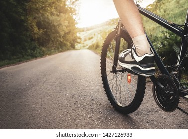 Teenager Riding A Bicycle On The Road Summer Sunlit