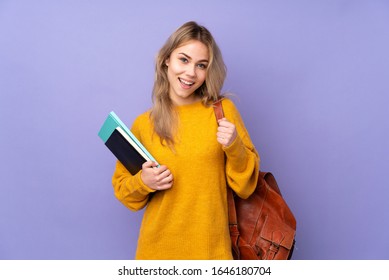 Teenager Russian student girl isolated on purple background celebrating a victory - Shutterstock ID 1646180704