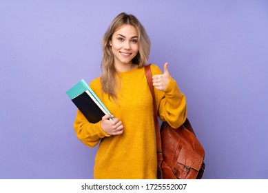 Teenager Russian student girl isolated on purple background showing ok sign and thumb up gesture - Shutterstock ID 1725552007