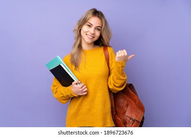 Teenager Russian student girl isolated on purple background with thumbs up gesture and smiling