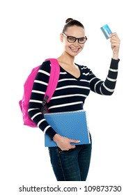 Teenager Showing Credit Card To Camera And Holding Spiral Book Isolated Over White Background