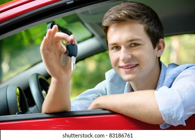teenager sitting in new car and shows the keys