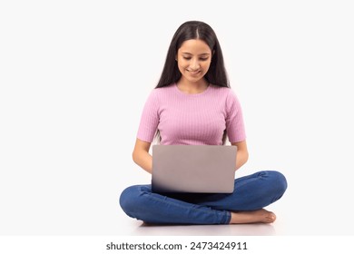 A TEENAGER SITTING AND USING LAPTOP - Powered by Shutterstock