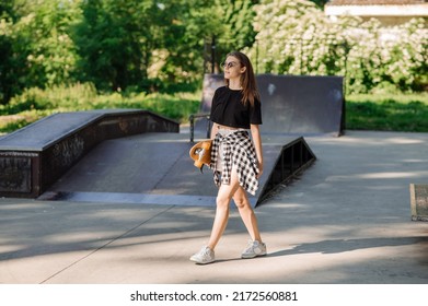 Teenager Skater Girl Holding Skateboard On The Skaters Park