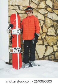 A Teenager In Snowboarding Gear 
Posing In The Snow