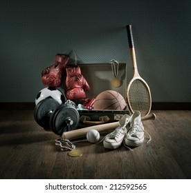 Teenager Sport Equipment In A Vintage Suitcase Including Sports Footwear, Boxing Gloves, Weights And Baseball Bat.