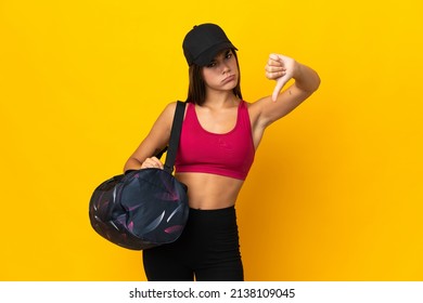 Teenager Sport Girl With Sport Bag Showing Thumb Down With Negative Expression