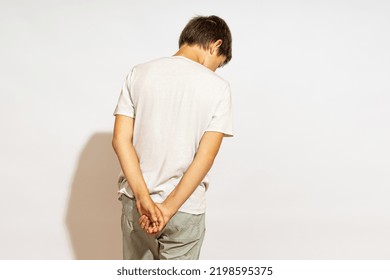 The Teenager Stands With His Back Turned And His Head Down. The Concept Of Punishment And Justice.