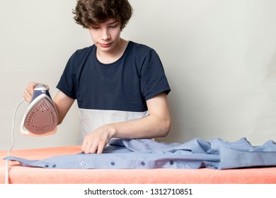 Teenager Stroking Ironing His Shirt Before Going To School