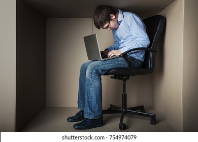 teenager, student in small office working on laptop, in an uncomfortable position, not enough space