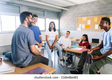 Teenager students listening and talking with friendly young male teacher - Group discussion in High School Education - Shutterstock ID 2186486481