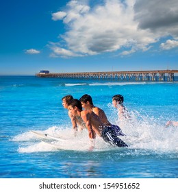 Teenager Surfers Surfing Running Jumping On Surfboards At Newport Pier Beach California [photo-illustration]