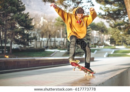 Similar – teenager practicing with skateboard at sunrise city