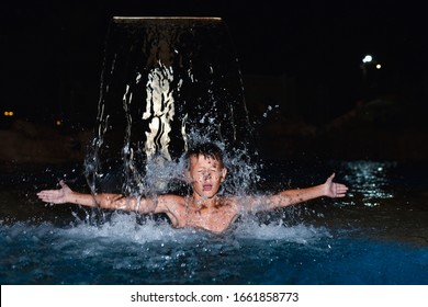 Teenager Swimming In The Pool At Night.