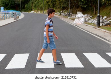 Teenager through a zebra crossing in his town - Powered by Shutterstock