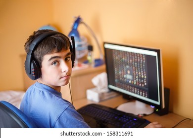 Teenager Using Computer At Home, Play Game In His Child Room