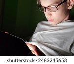 teenager using his phone in bed at nigh concept