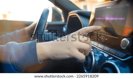 Teenager using touch screen while driving a car. Security, technology, communication concept.