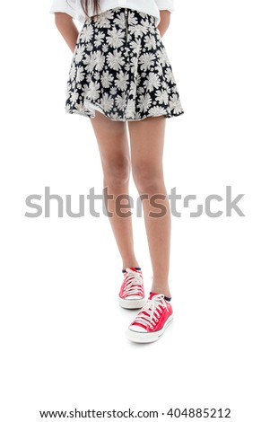 Teenager wearing red sneakers on white background.