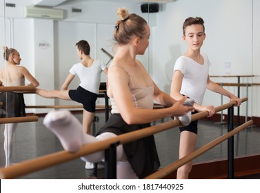Teenager and women practicing at the ballet barre. High quality photo