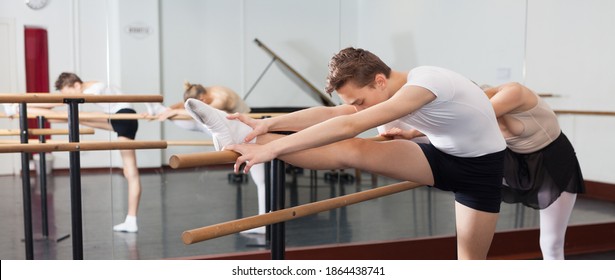 Teenager and women practicing at the ballet barre. High quality photo - Powered by Shutterstock