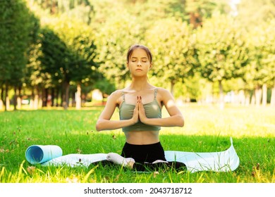 Teenager Yoga Outside,young Girl In The Park Is Sitting In The Lotus Position, A Girl In Nature, Health Outdoor