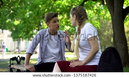 Teenagers arguing in park, break up because of misunderstanding, conflict