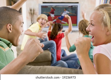 Teenagers Cheering At The TV