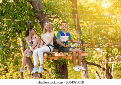 Teenagers Climbing In Adventure Park