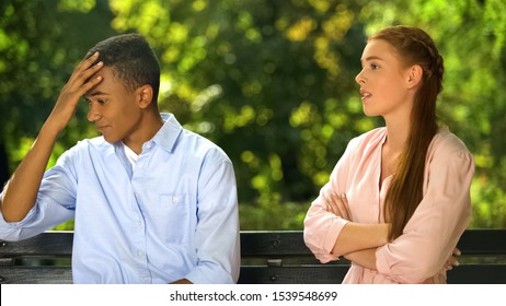 Teenagers Couple Quarreling Sitting On Bench In Park, Relations Problem Break Up