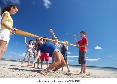 Teenagers Doing Limbo Dance On Beach