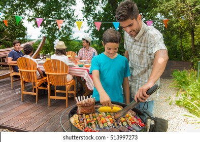 Teenagers During A Barbecue At Family Garden BBQ, Outdoor