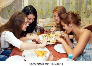 Teenagers Eating Pizza In Restaurant