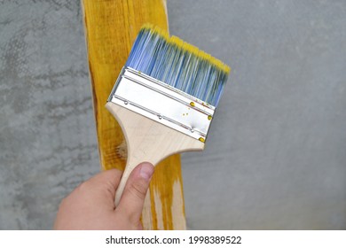 The Teenager's Hand Applies An Antifungal Solution For Wood Processing With A Brush.The Concept Of Child Labor And Adult Assistance,wood Surface Treatment,favorite Hobby, Drawing, Design, Farm Repair