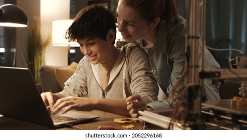 Teenagers Learning 3D Modeling And Using A 3D Printer, The Boy Is Using A Laptop And The Girl Is Helping Him